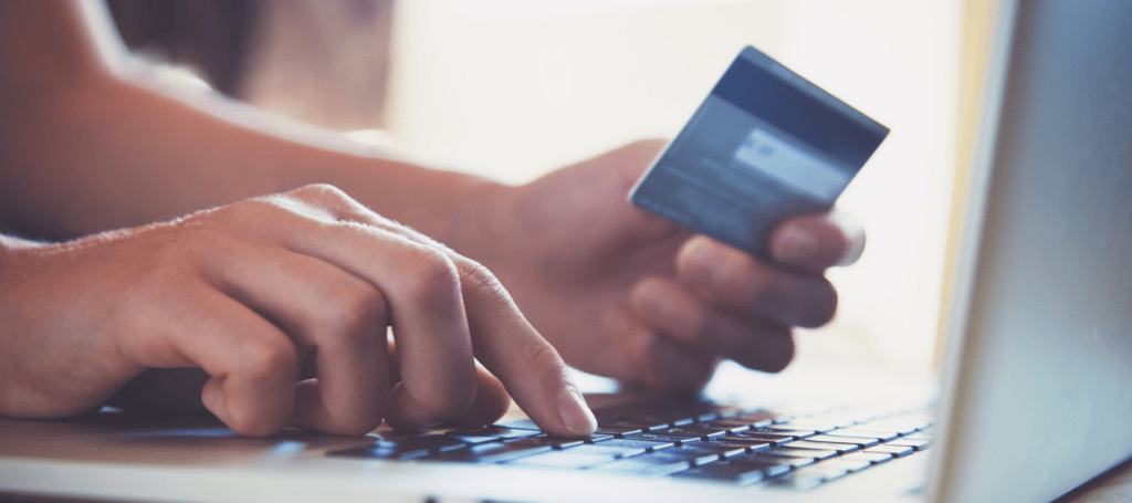 hands holding a credit card and typing in financing information