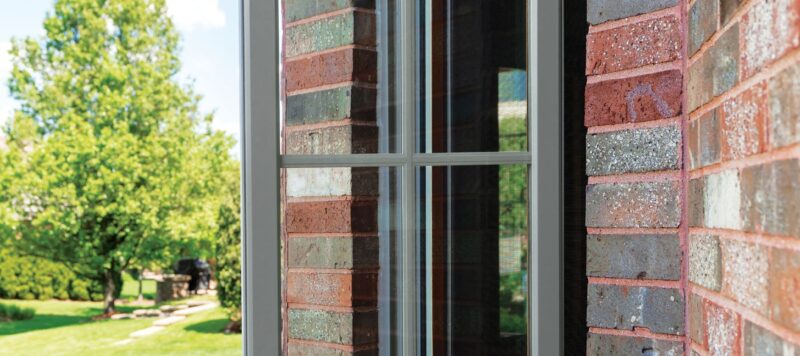 a casement window opening outwards from a brick home