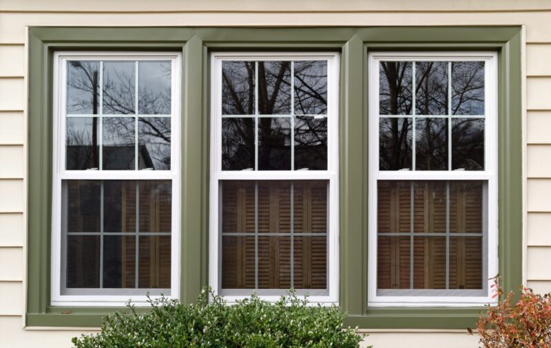 3 marvin windows with white trim on a green house