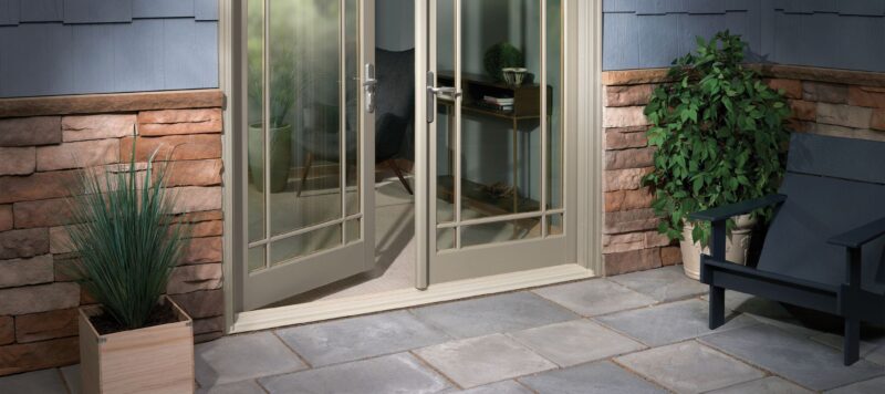 two patio doors with one opening inwards into a home